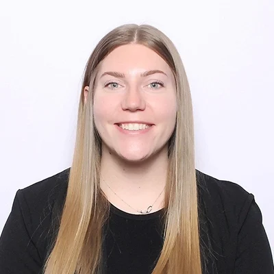 Victoria smiling in a black shirt.